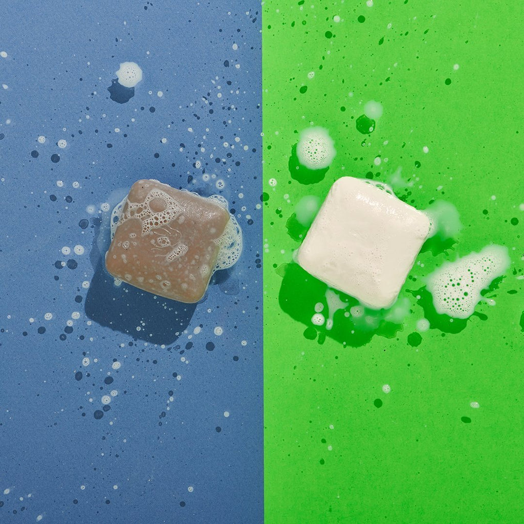 Lathered Juju Exfoliating and Pekee Cleansing Bars on Blue and Green Background